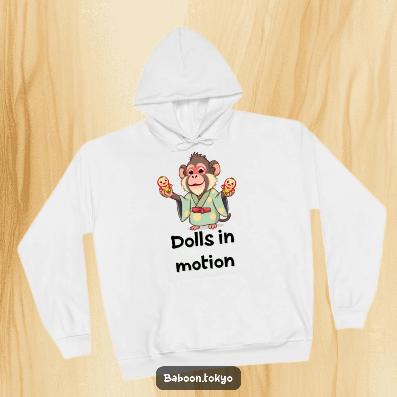 Funny hoodie: a whimsical baboon in a bright kimono juggling three small toy Daruma dolls, exuding fun and playful energy.